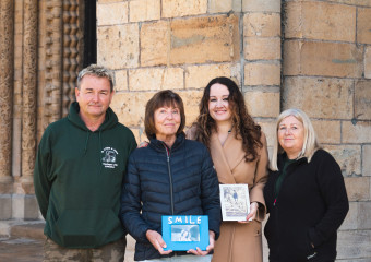 Members, of the Lyon family, together at Lincoln Cathedral, holding photographs of Sharon, who was cared for by the hospice before she passed away.